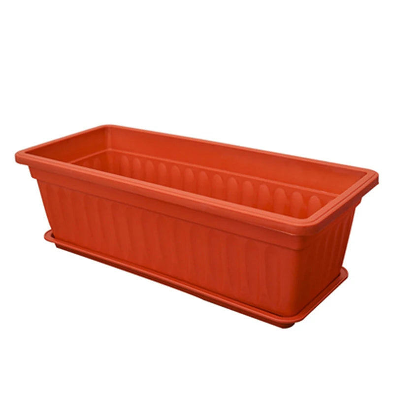 Empty rectangular terracotta-colored plastic planter with vertical fluted sides and a matching drip tray.