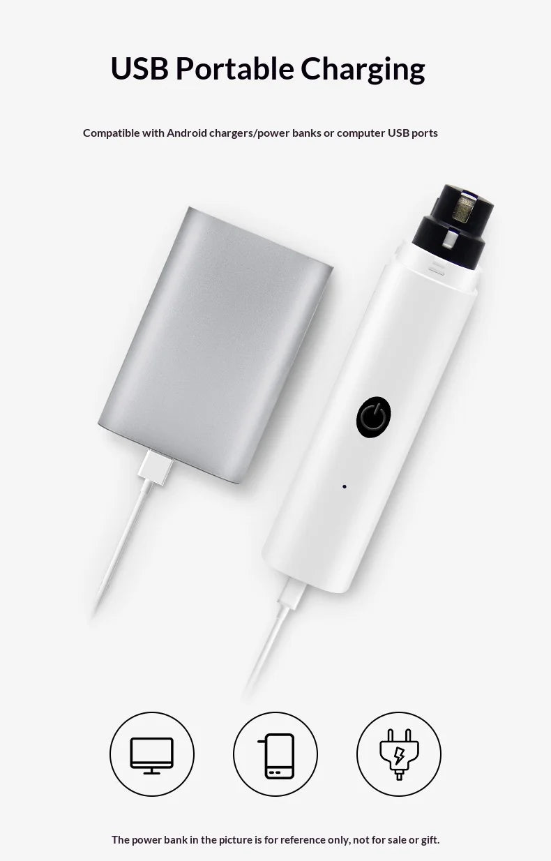 White electric pet nail grinder being charged via USB cable from a silver power bank.