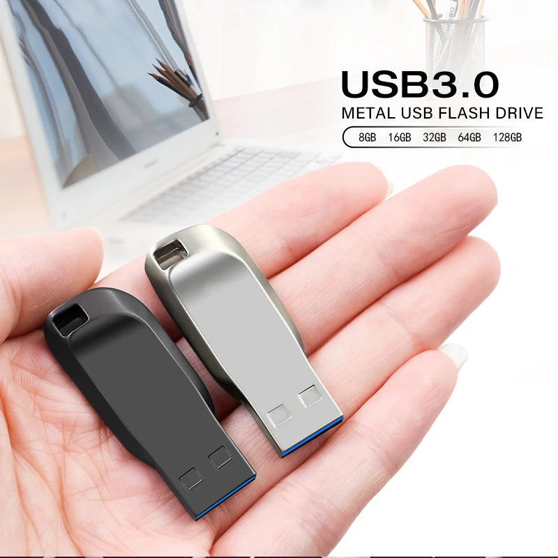 A hand holding two sleek, compact metal USB 3.0 flash drives in silver and matte black finishes.