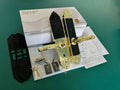 Gold and black metal smart door lock with biometric fingerprint scanner, keys, and access cards in its original box.