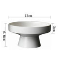 Minimalist white pedestal bowl with a textured matte finish, 13cm diameter and 6.8cm total height.