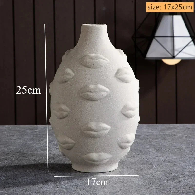 Off-white ceramic vase featuring an embossed, all-over lip pattern. Measures 17cm wide by 25cm tall.