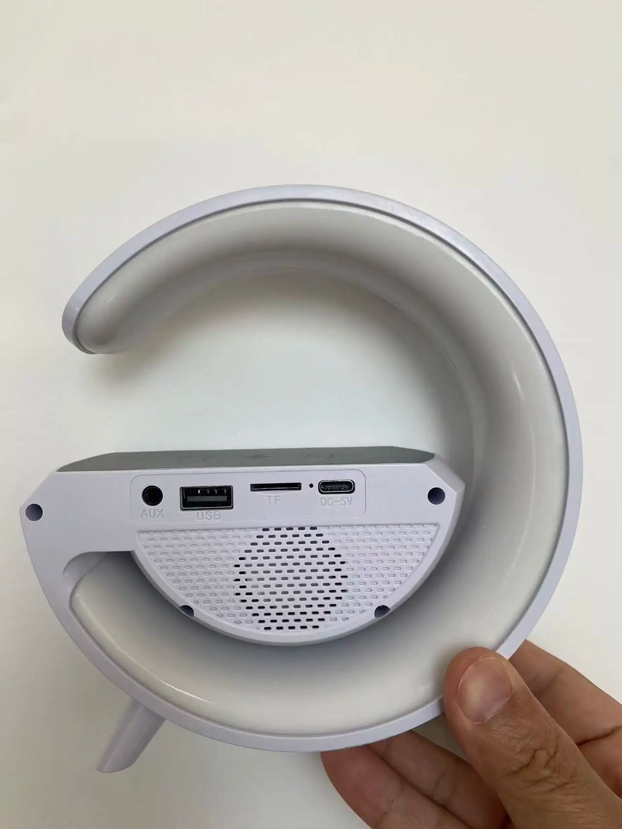 White circular smart lamp with a speaker base, featuring USB, AUX, and charging ports on the rear.