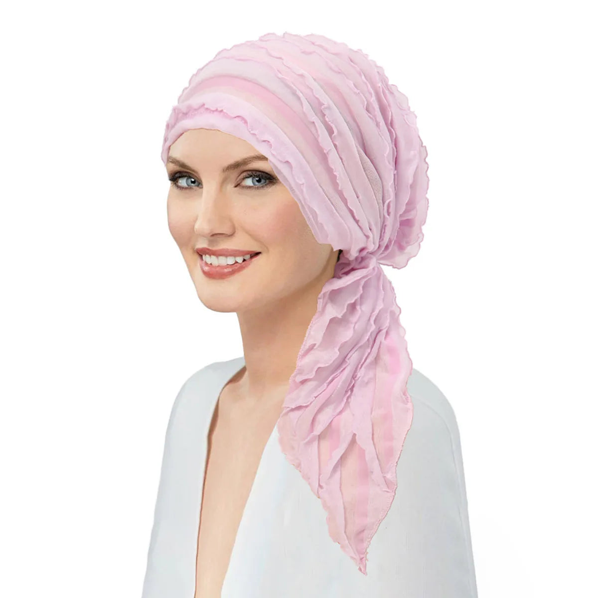 A model wearing a soft pink pre-tied elastic turban head wrap featuring elegant tiered ruffle detailing.