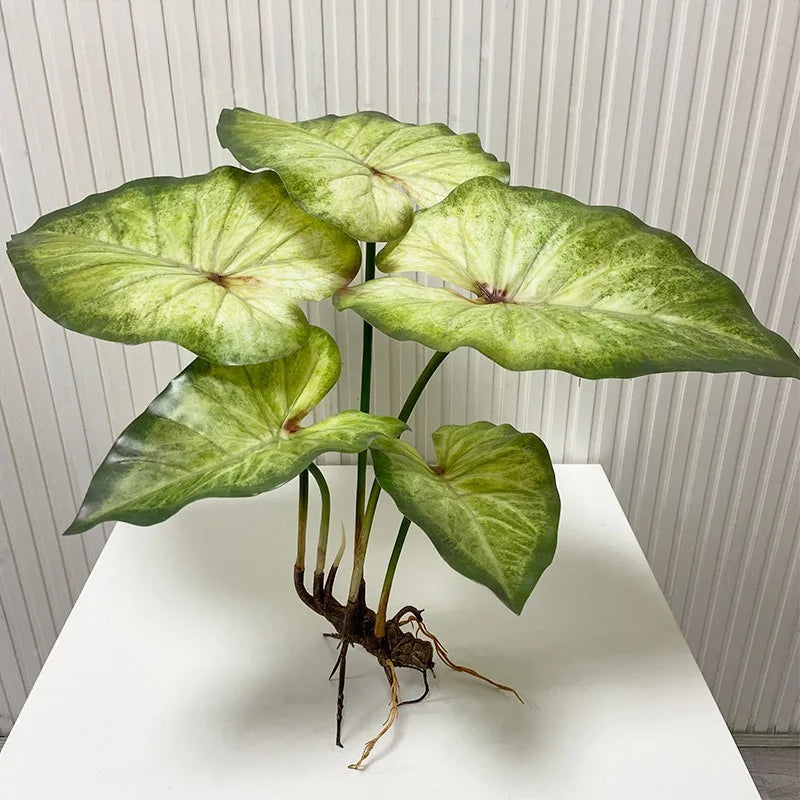 Artificial lotus plant with large, mottled green leaves and visible exposed brown roots against a white background.