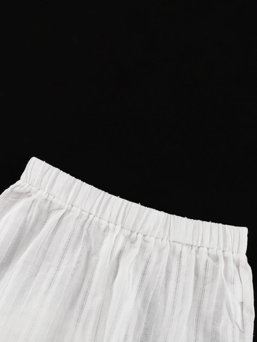 White shorts with a comfortable elasticated waistband and subtle vertical striped textured fabric.