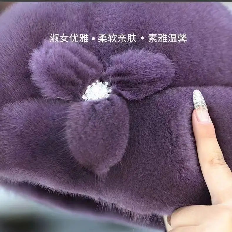 Elegant deep purple faux fur winter hat, featuring a plush floral detail with a central sparkling crystal embellishment.