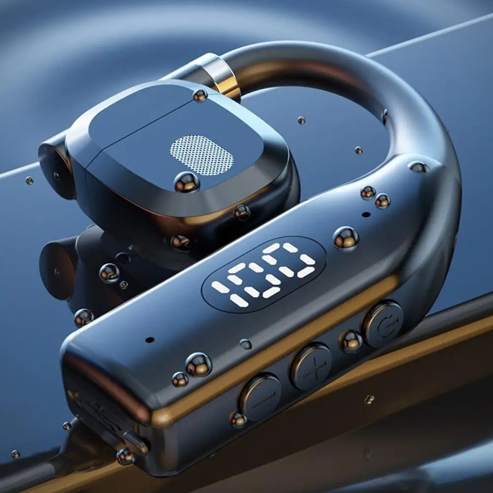 Dark metallic ear-hook headset with a digital battery display and physical control buttons on a reflective surface.