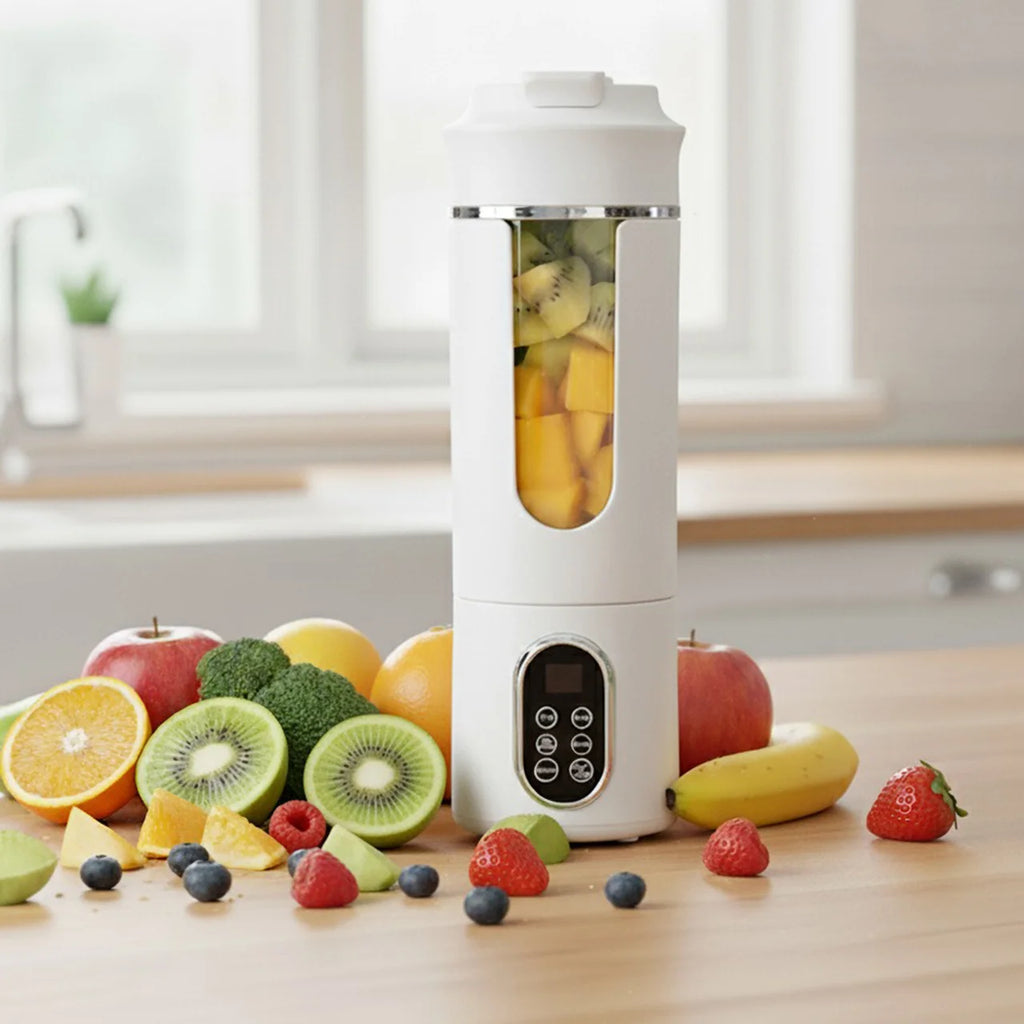 White portable blender with a digital display, transparent central window, and fruit scattered on a wooden kitchen table.
