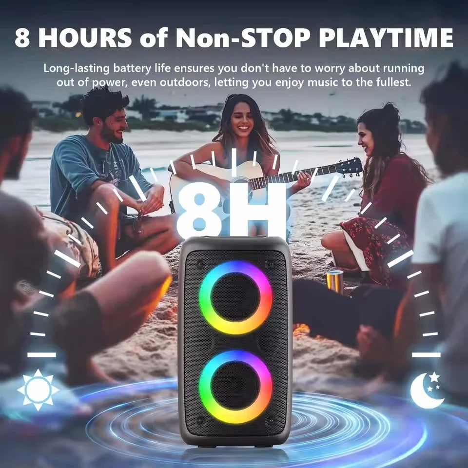 Portable black Bluetooth speaker with vibrant LED light rings around the two main speakers, set against a beach scene.