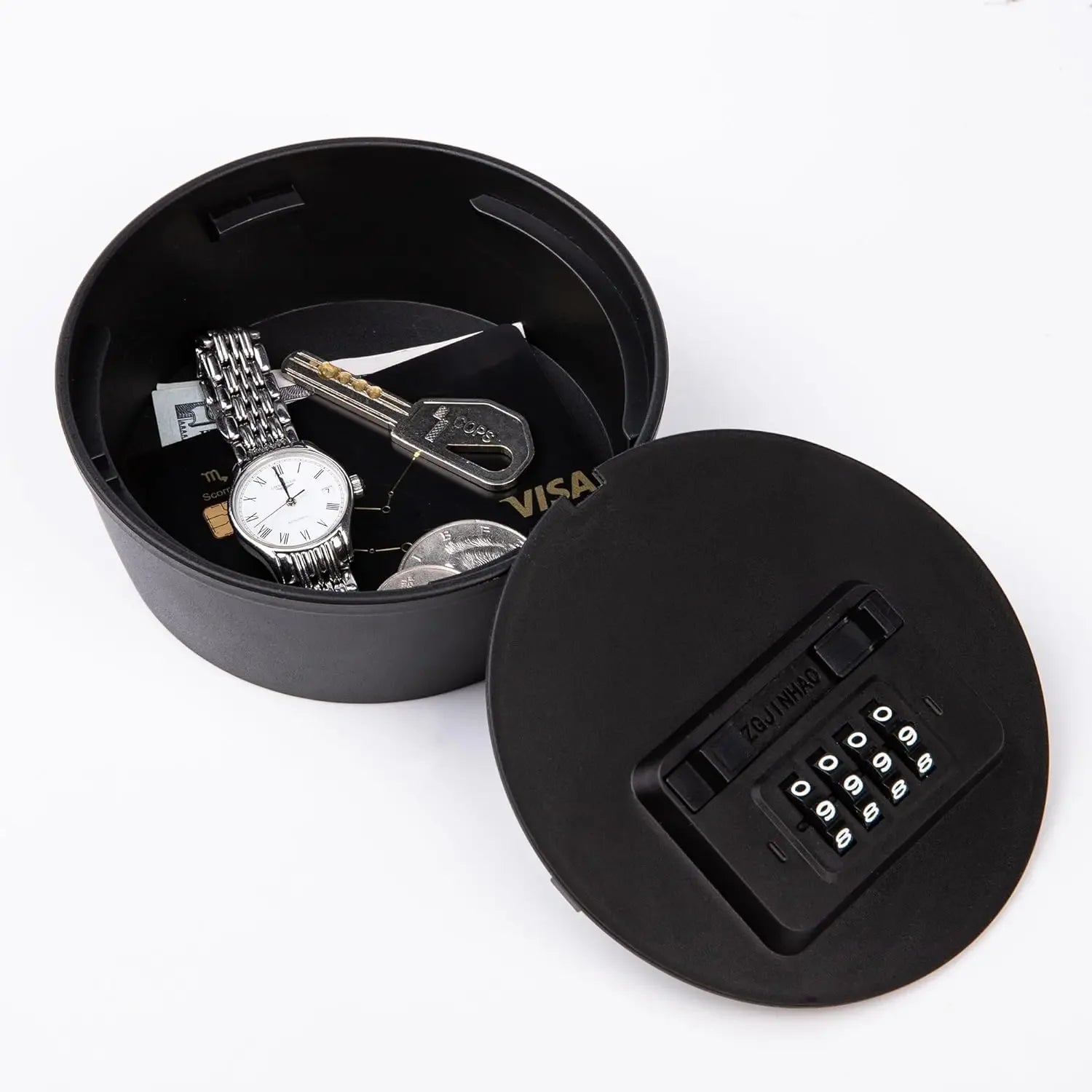 Black round plastic storage box with a combination lock lid containing a watch, key, coins, and bank cards.