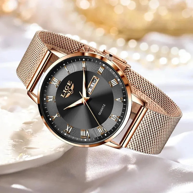 Elegant rose gold stainless steel women’s watch with a black dial, Roman numerals, and a mesh bracelet strap.