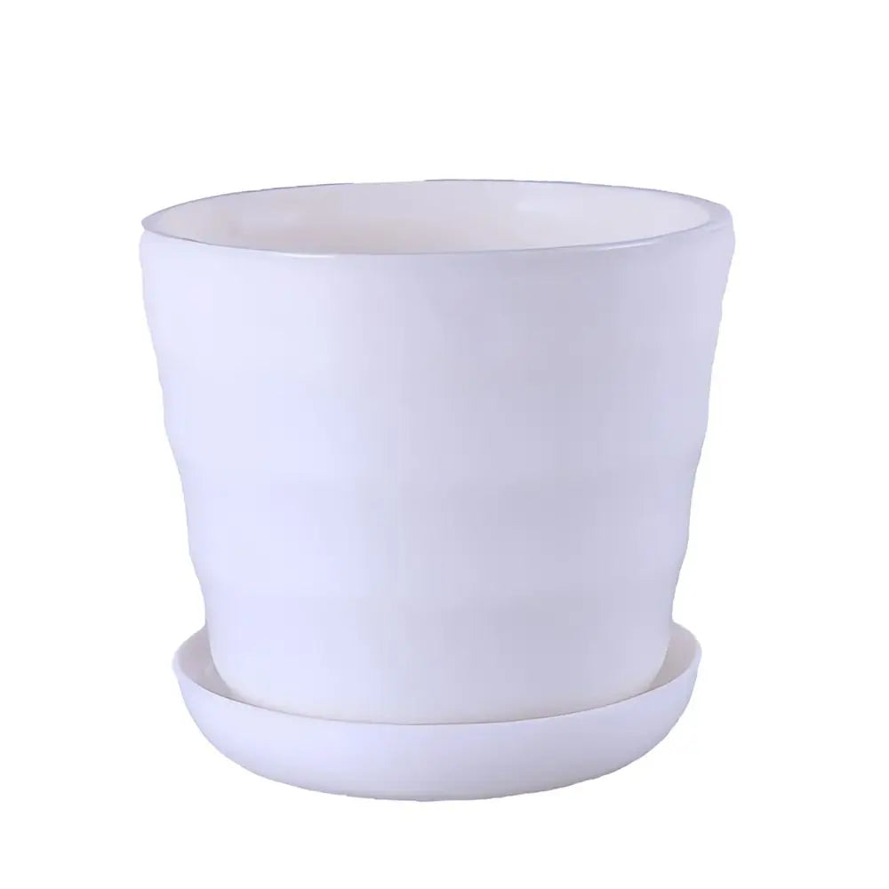 A white, cylindrical plastic flower pot with a subtle ribbed texture and matching saucer on a plain background.