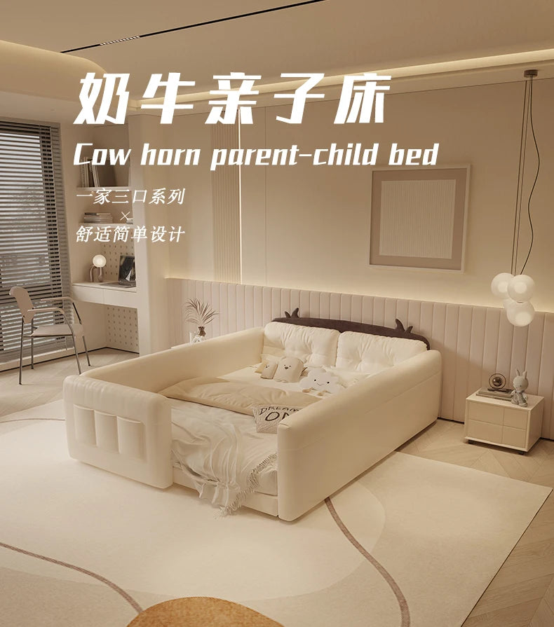Cream-coloured parent-child bed with protective padded guardrails, cow horn detailing, and integrated storage.