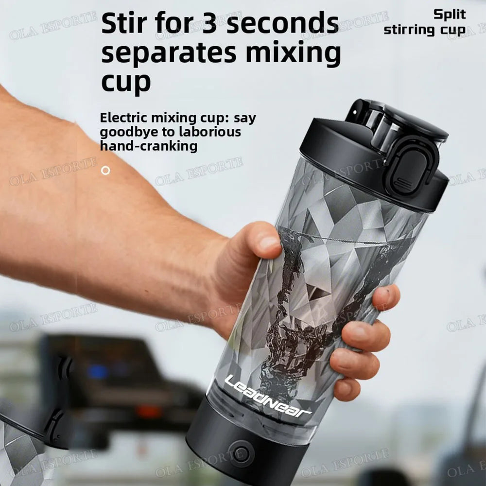 A hand holds a black and silver electric mixing cup featuring a geometric pattern and a secure, flip-top lid.