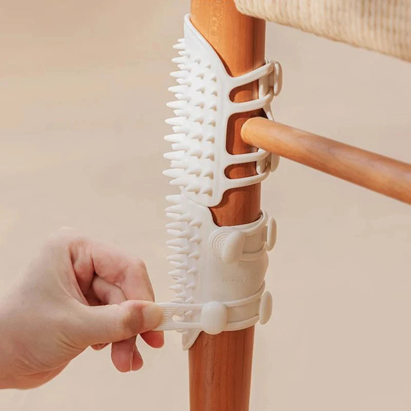 White silicone pet scratch guard being strapped around a wooden chair leg.