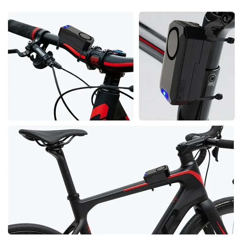 Black plastic bicycle alarm mounted on a bike frame and handlebar with zip ties, featuring a siren and blue light.