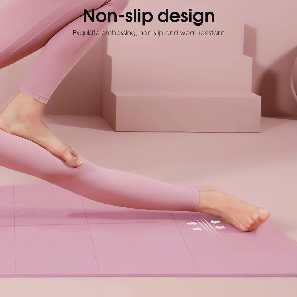 Close-up of a person in pink leggings using a textured, non-slip dusty pink yoga mat.