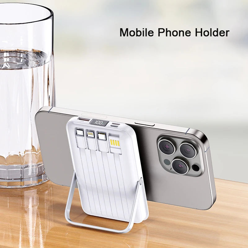 White 20,000mAh magnetic power bank with integrated cables and foldable stand supporting a smartphone.