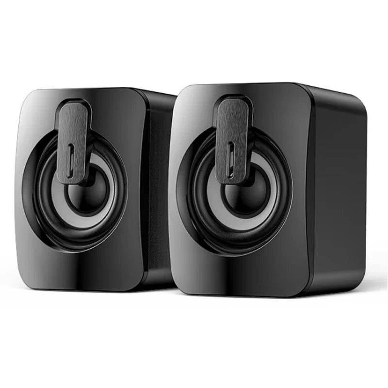 A pair of compact, black wired USB stereo speakers with modern rounded corners and exposed central drivers.