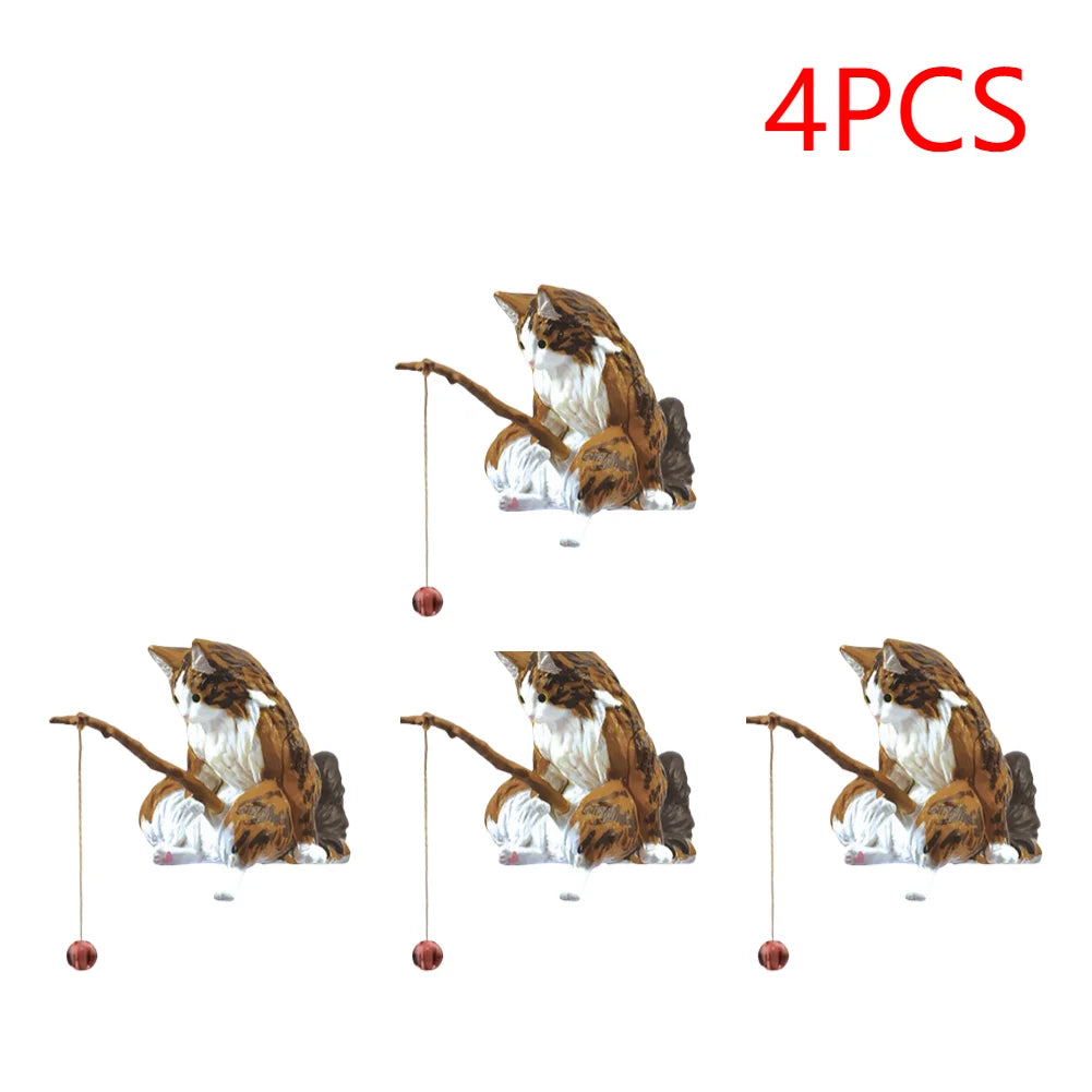 A set of four brown and white tabby cat aquarium ornaments, each sitting and holding a toy fishing rod.