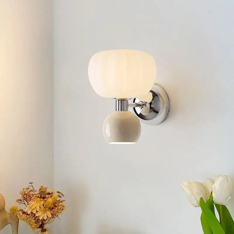 Modern cream-coloured double-head wall lamp with a textured glass shade and a polished chrome base.