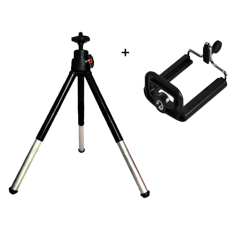 Black tabletop tripod with extending silver legs and a separate black universal smartphone mount attachment.