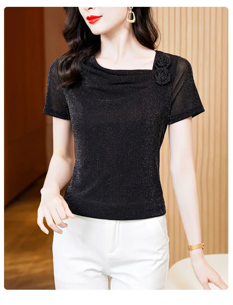 Black shimmering short-sleeve top with a cowl neckline, rose floral accent, and sheer mesh sleeves.
