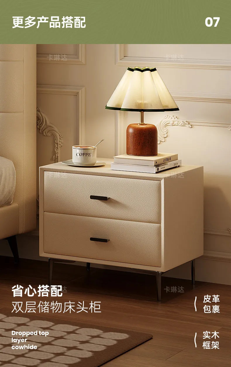 Minimalist cream-coloured two-drawer bedside table with a sleek wooden frame and slender metal legs.