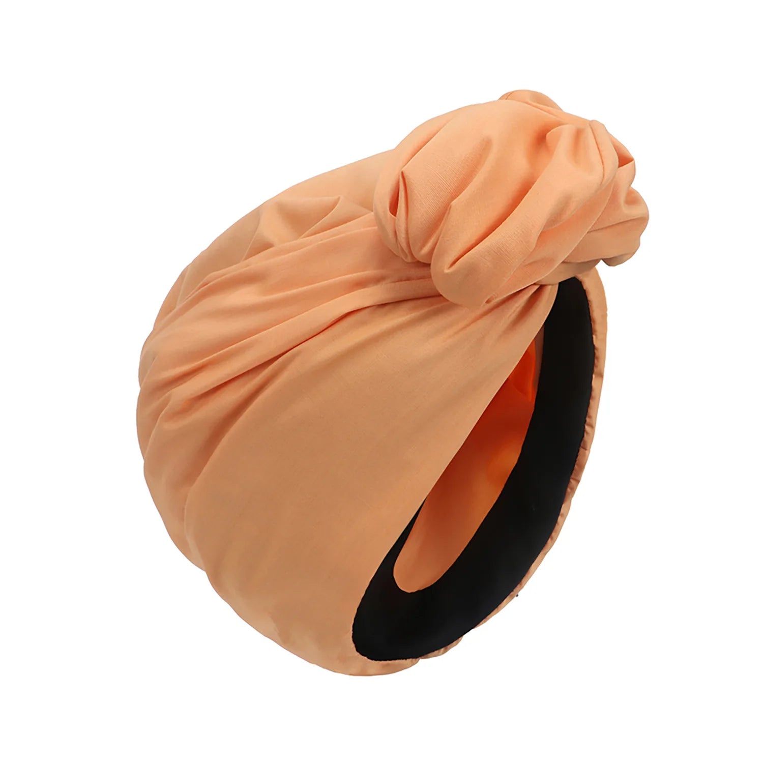 Peach-coloured vintage-style turban hat with a knotted front detail and a black interior lining.