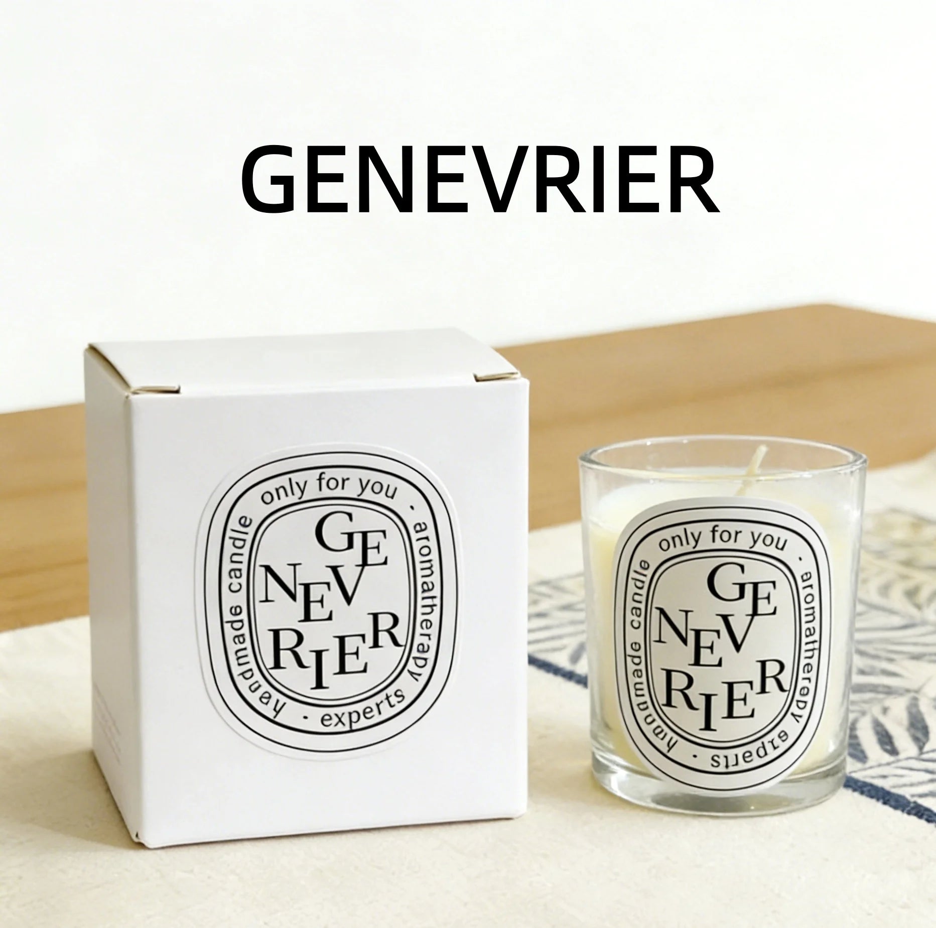 Aromatherapy scented candle in a glass votive with matching white gift box, featuring minimalist black text labels.