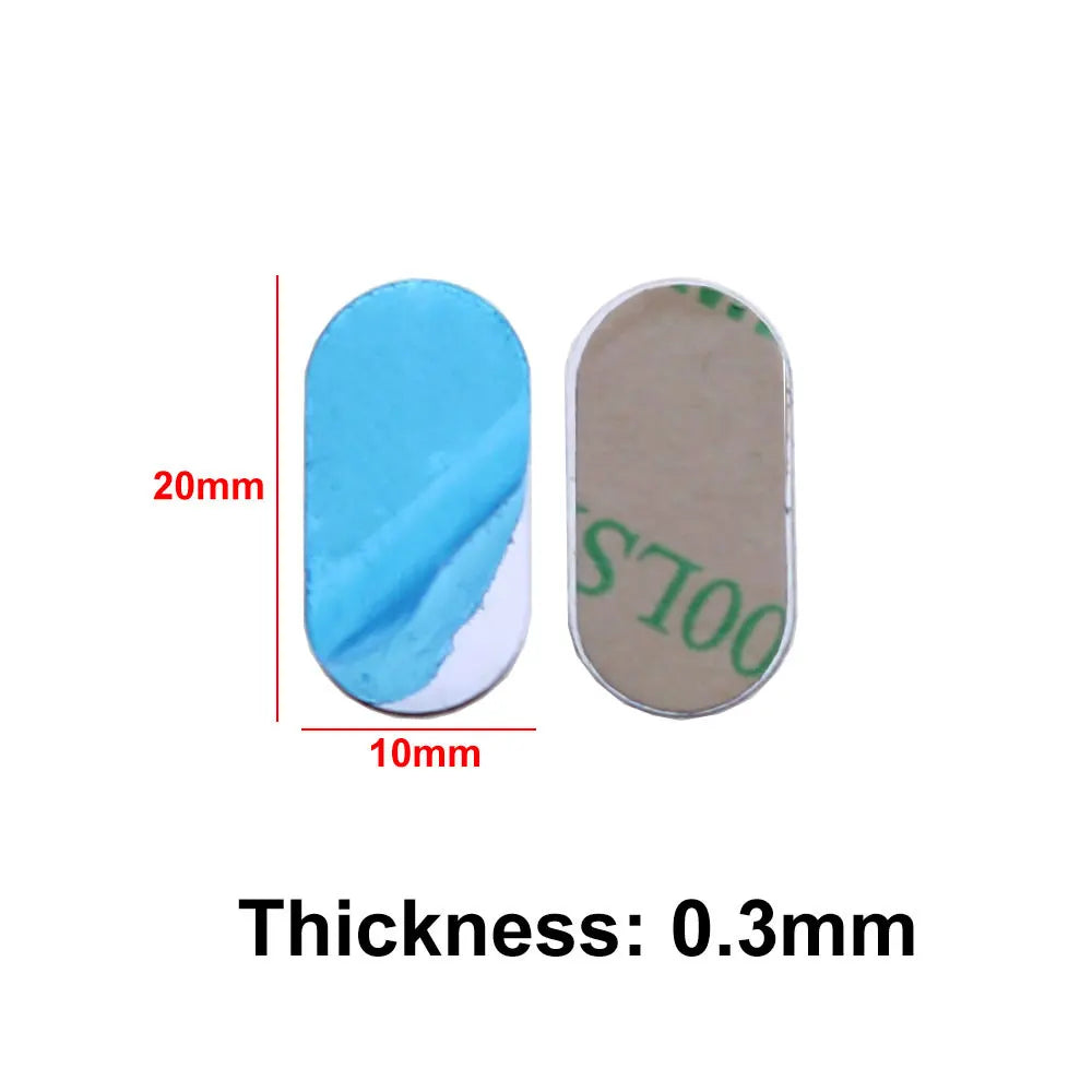 Two small oval adhesive pads, 20mm by 10mm, with blue and tan protective backings and a thickness of 0.3mm.