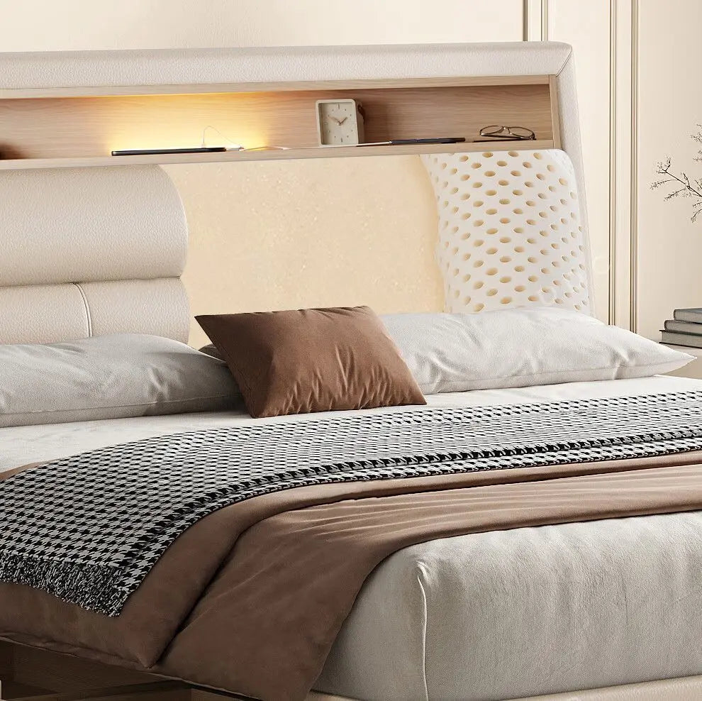 Luxury cream leather bed frame with an integrated wooden headboard shelf, ambient lighting, and modern design.