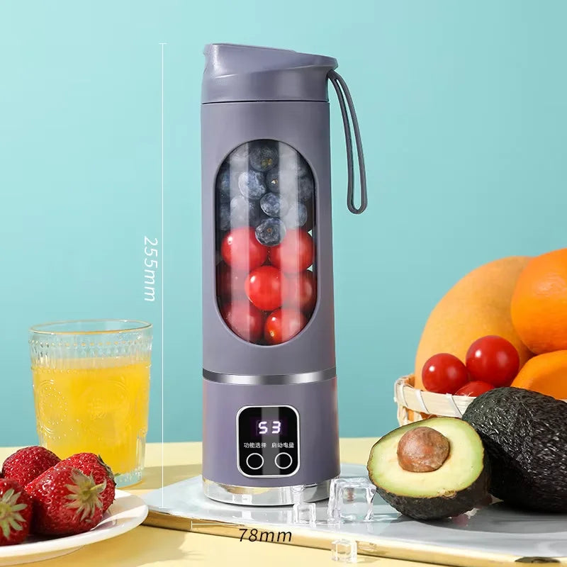 Grey portable blender with a digital display, filled with blueberries and tomatoes, standing on a kitchen counter.