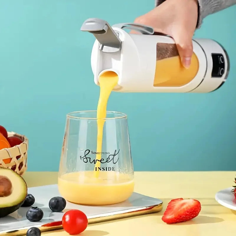 White portable smoothie blender pouring yellow juice into a glass printed with "Something Sweet Inside".