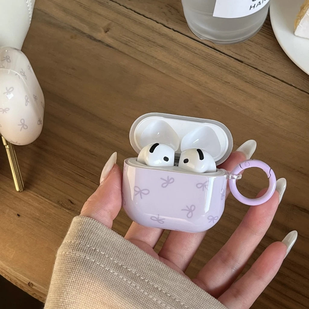 Lilac silicone AirPods case with white bow print and matching ring holder, compatible with AirPods 3.