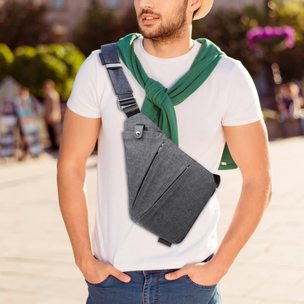 Grey slimline waterproof crossbody chest bag with adjustable strap, worn over a white t-shirt.