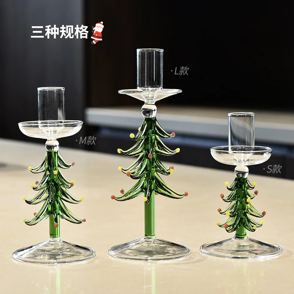 Three green borosilicate glass Christmas tree candle holders in different sizes with clear candle cups on top.