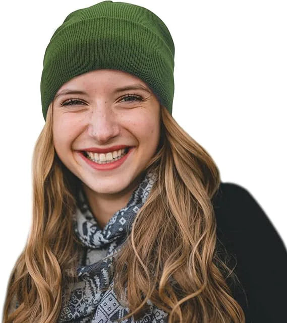 A smiling woman wearing a plain olive-green knitted beanie hat.