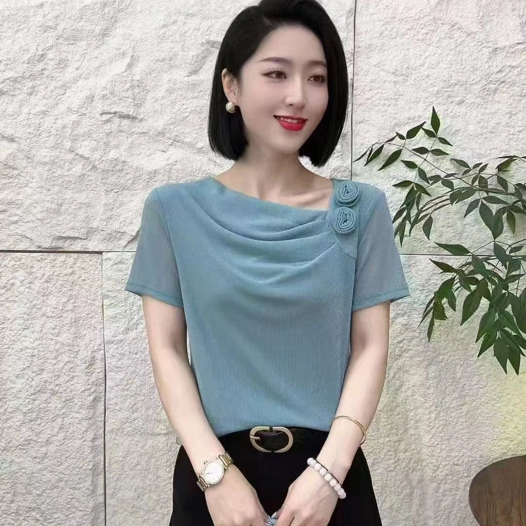 Blue short-sleeve top with a cowl neckline, rosette shoulder detail, and sheer mesh fabric sleeves.