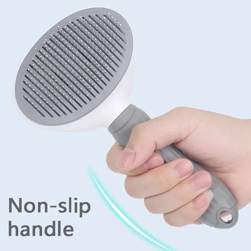 A hand holding a white and grey pet grooming slicker brush with a textured non-slip handle against a blue background.