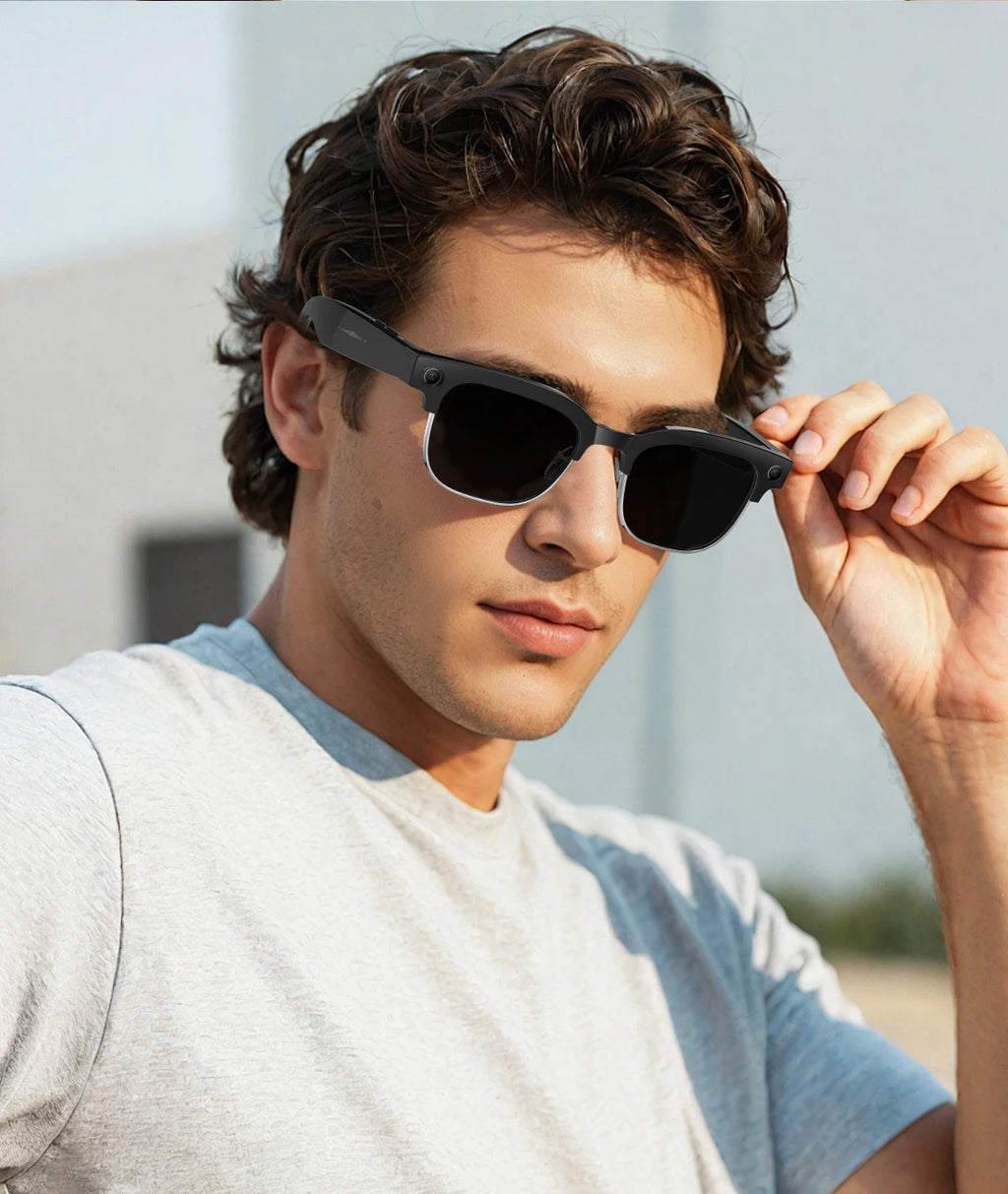 A man wearing stylish black smart glasses with integrated cameras for recording and translation features.