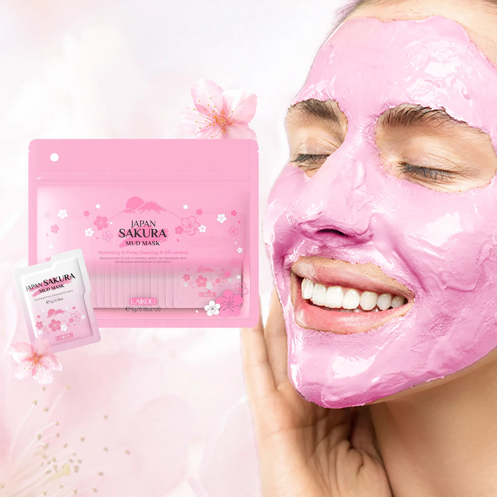 Woman wearing a pink sakura-infused mud mask for hydration and pore control, with matching product packaging.