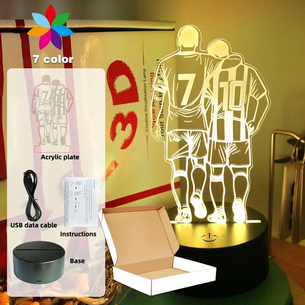 3D LED lamp featuring two footballers on an acrylic plate with 7-colour settings, USB cable, base, and gift box.