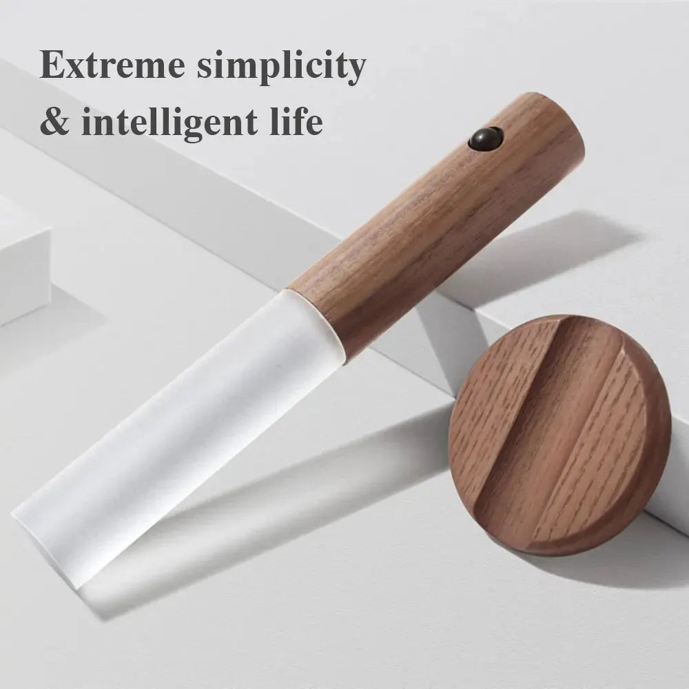 Modern wooden motion-sensor LED night light with a frosted white shade and matching circular magnetic base.