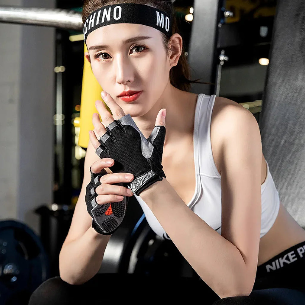 Woman in a gym wearing black and grey fingerless weightlifting gloves with cushioned, textured palms.