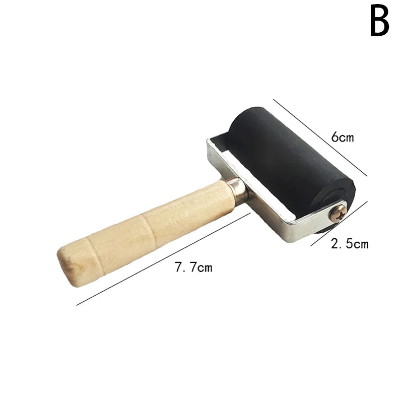 Craft roller with a black rubber brayer, metal frame, and natural wooden handle. Includes size dimensions.