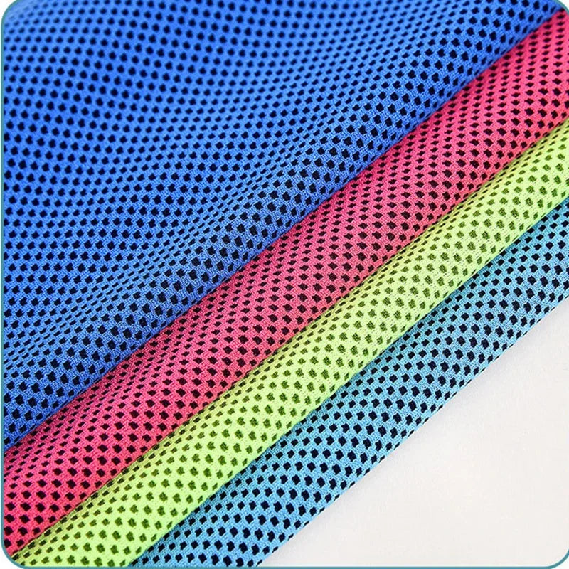 Four cooling towels in blue, pink, lime green, and light blue, layered to show the textured, mesh fabric pattern.