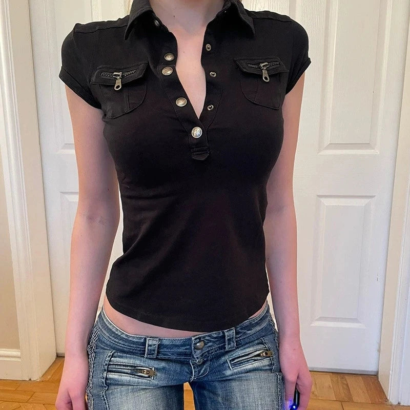 Black short-sleeved polo shirt with silver button-down front and two zipped chest pockets. Slim-fit casual style.