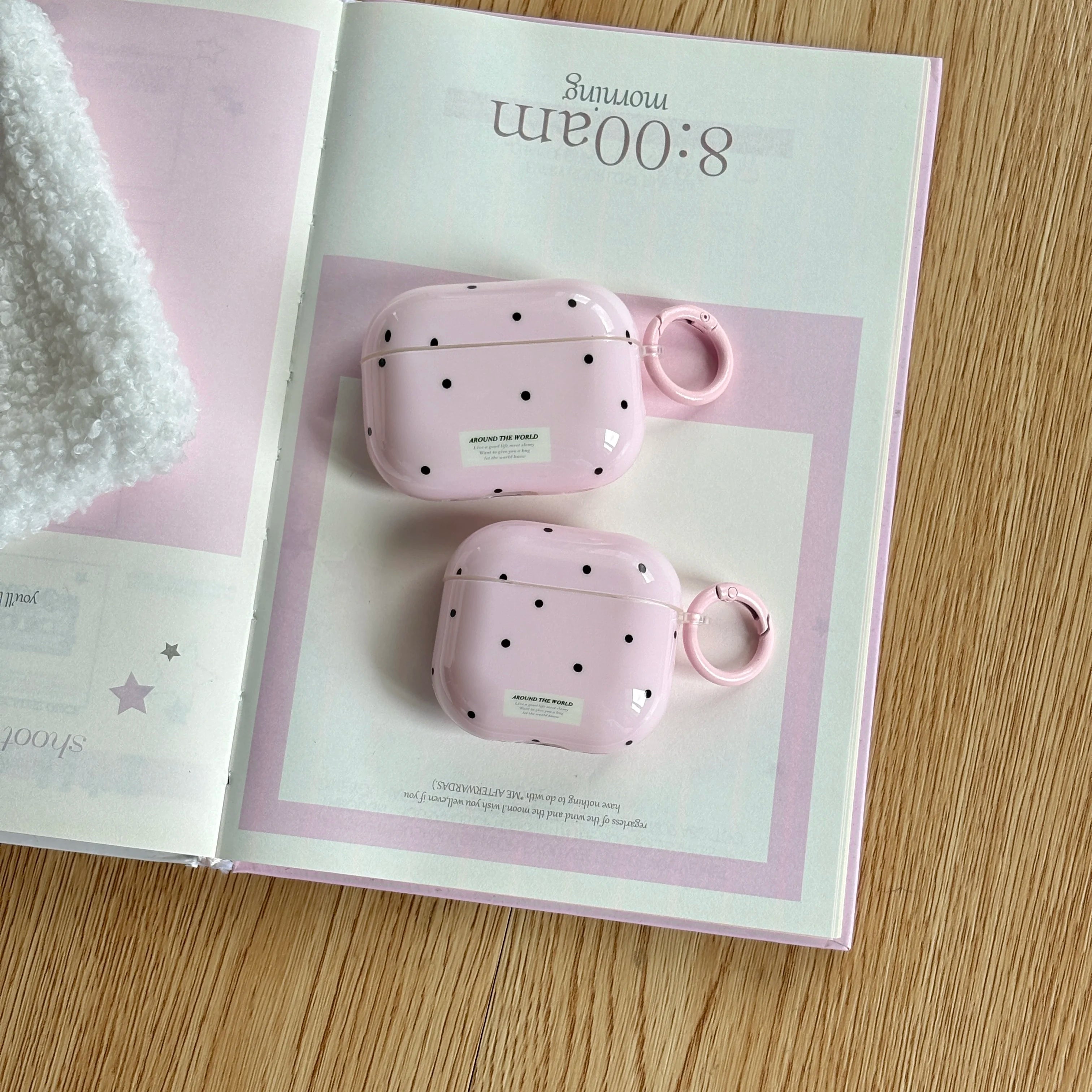 Pink polka dot hard shell cases for AirPods Pro and standard AirPods with matching ring clips.
